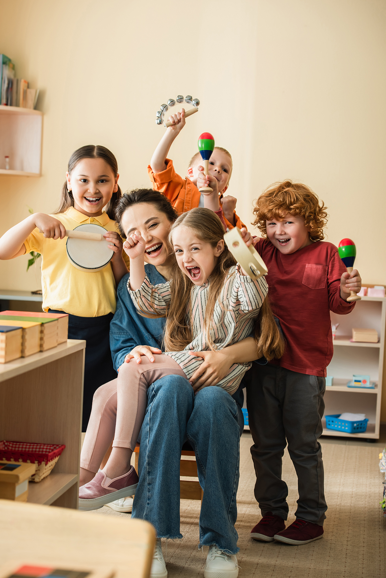 Joyful,Multiethnic,Kids,With,Teacher,Playing,Musical,Instruments,In,Classroom